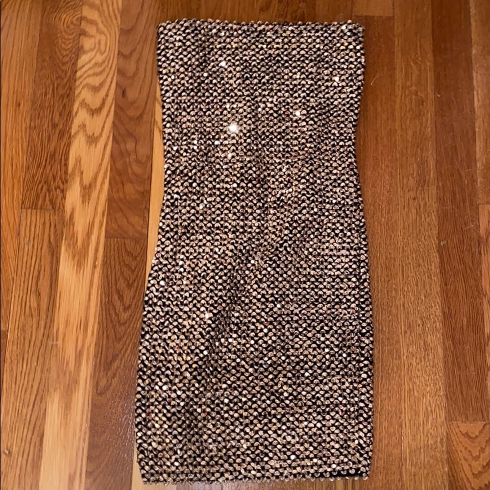 A gold strapless sequin dress